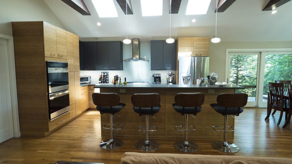 A brown kitchen with a central island and bar stools