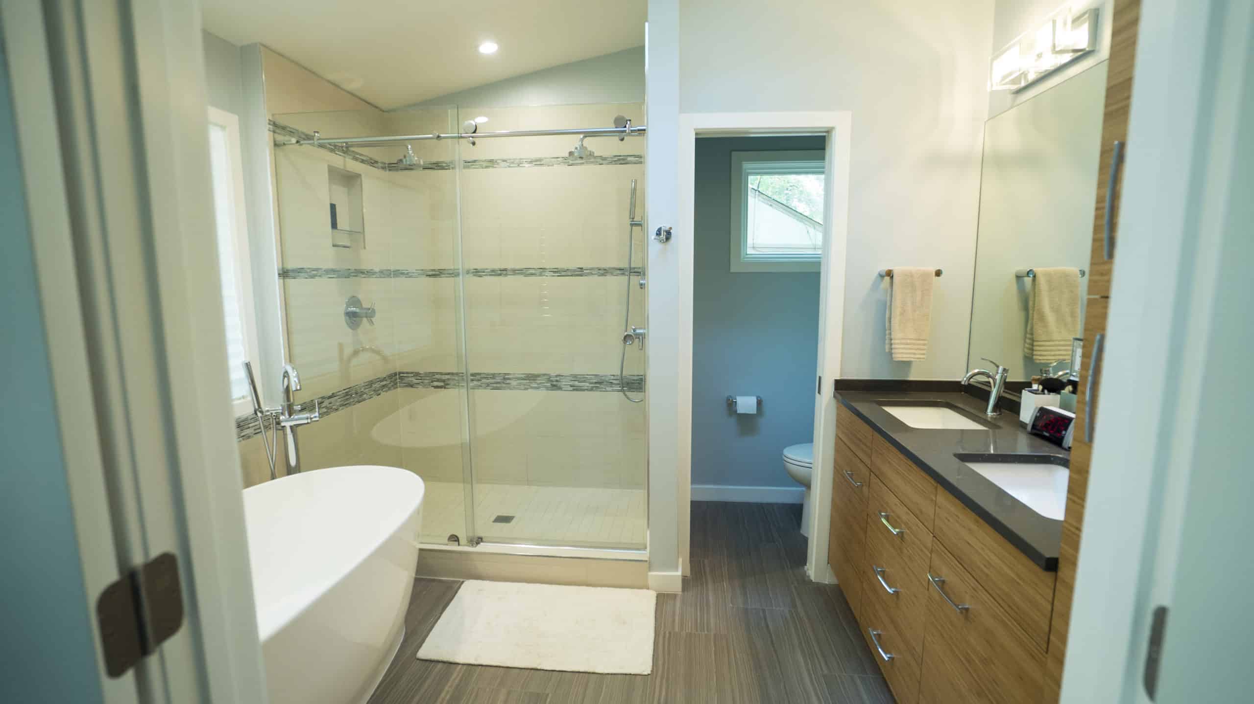 A modern bathroom featuring a spacious walk-in shower and a sleek sink