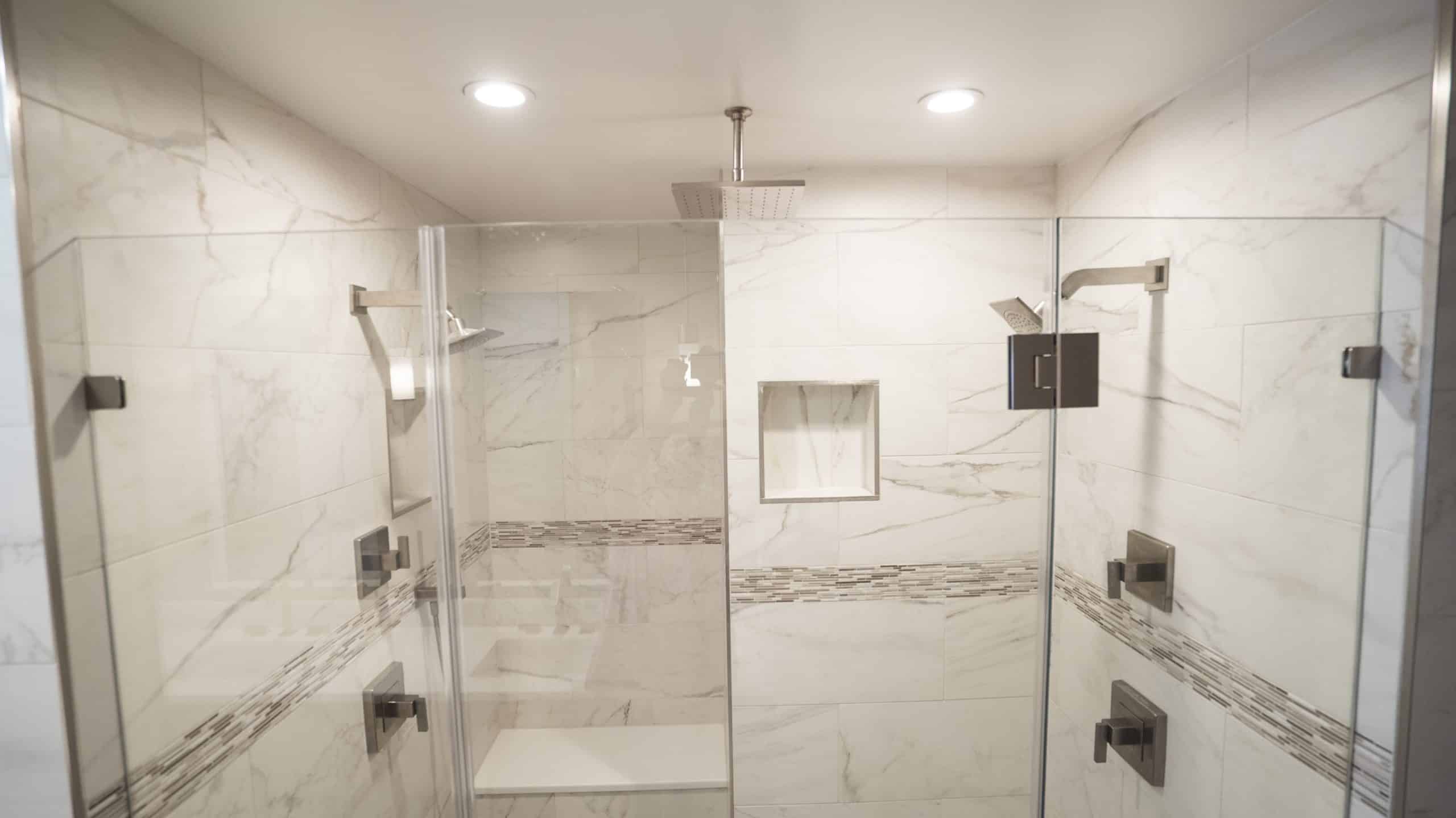A modern walk-in shower with sleek glass doors and a transparent glass door