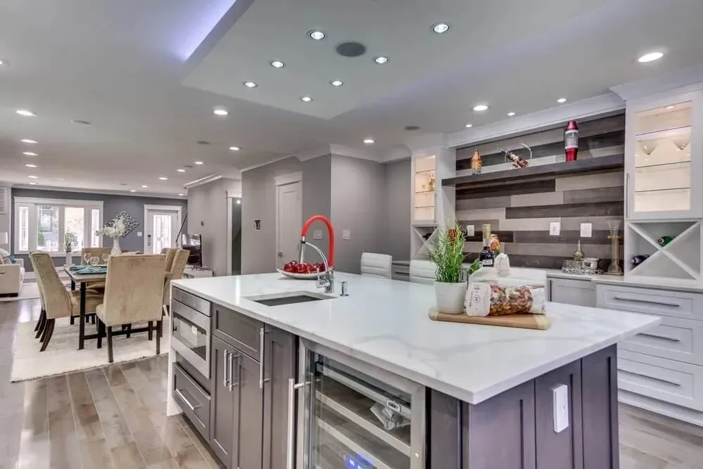 45 Kitchen Remodeling Ideas for 2026 | USA Cabinet Store 32 Luxury gray and white kitchen remodel with wine cooler island and custom bar