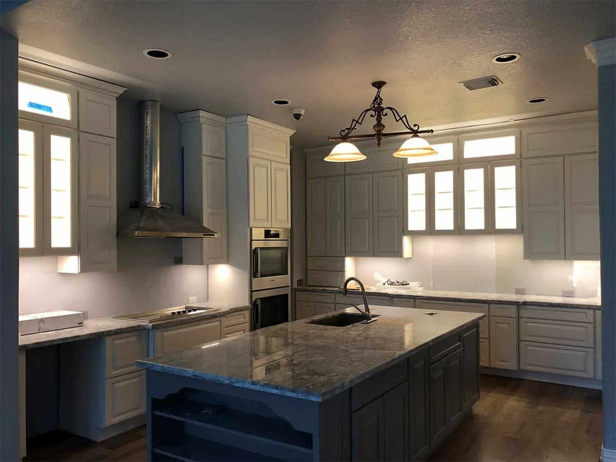 Kingwood kitchen remodel in Houston featuring Showplace Covington cabinets and a quartzite island with integrated sink