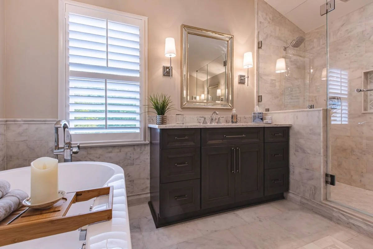 Master bathroom layout with freestanding tub, dark wood vanity, and glass shower in Ashburn VA.