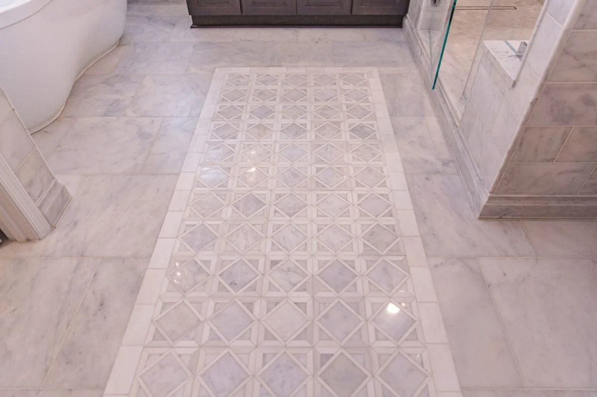 Geometric marble mosaic floor inlay with diamond pattern in an Ashburn VA master bathroom renovation.