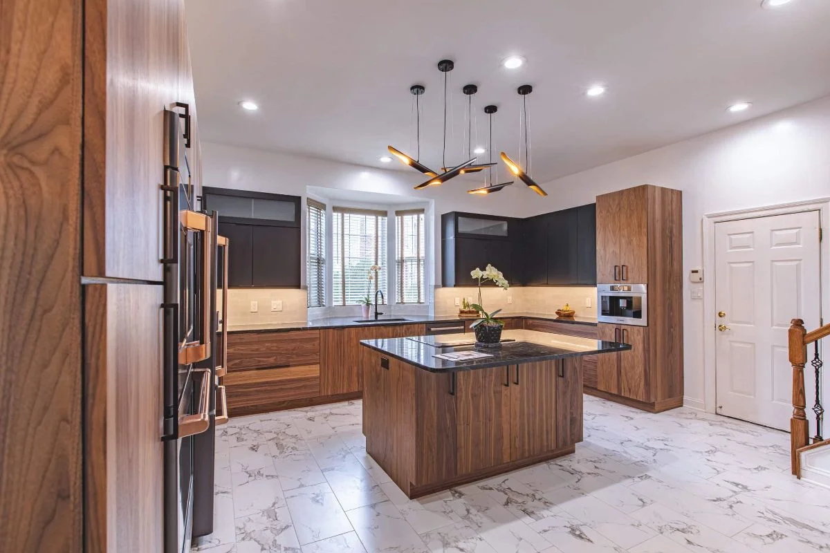How Much Does a Kitchen Remodel Cost in 2026? 20 Modern kitchen with walnut cabinetry, matte black cabinets, and a waterfall island What Real Homeowners Say About Kitchen Remodel Costs?