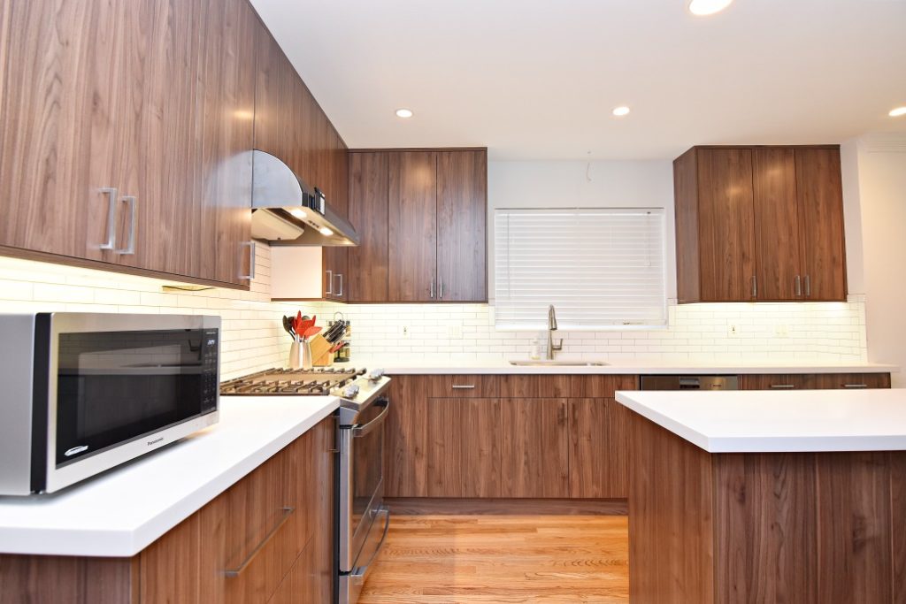 A kitchen with wooden cabinets