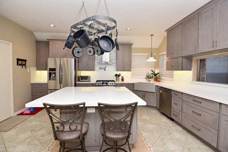 USA Cabinet Store Launches Regional Kitchen Remodeling Services Model 1 Horizon kitchen remodel in Houston with gray cabinets, white island seating, hanging pot rack, and stainless steel appliances Regional kitchen remodeling services