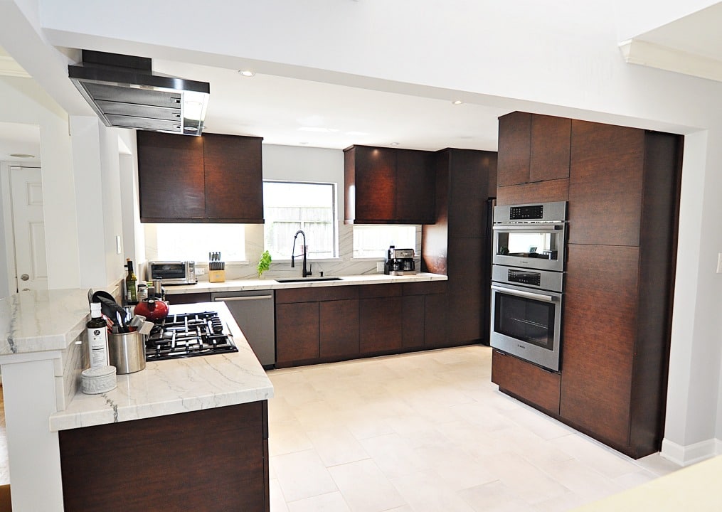 A fully equipped kitchen with a stove, oven, sink, and refrigerator