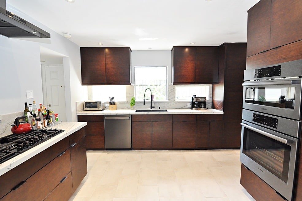 A fully equipped kitchen with a stove, oven, sink, and refrigerator