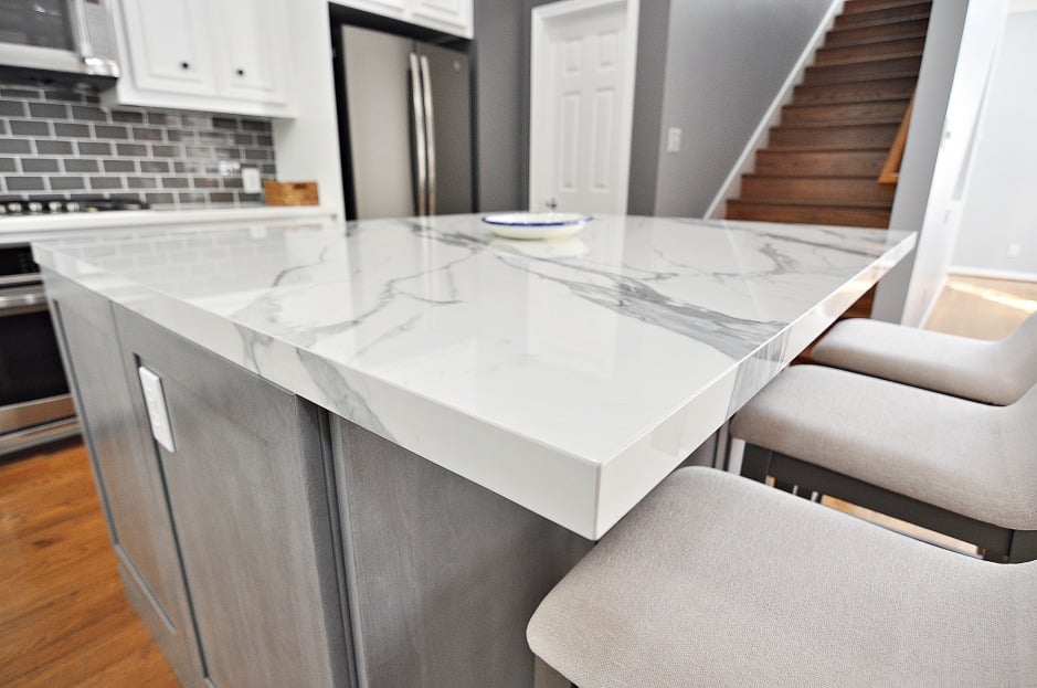 A kitchen island with sleek marble counter tops