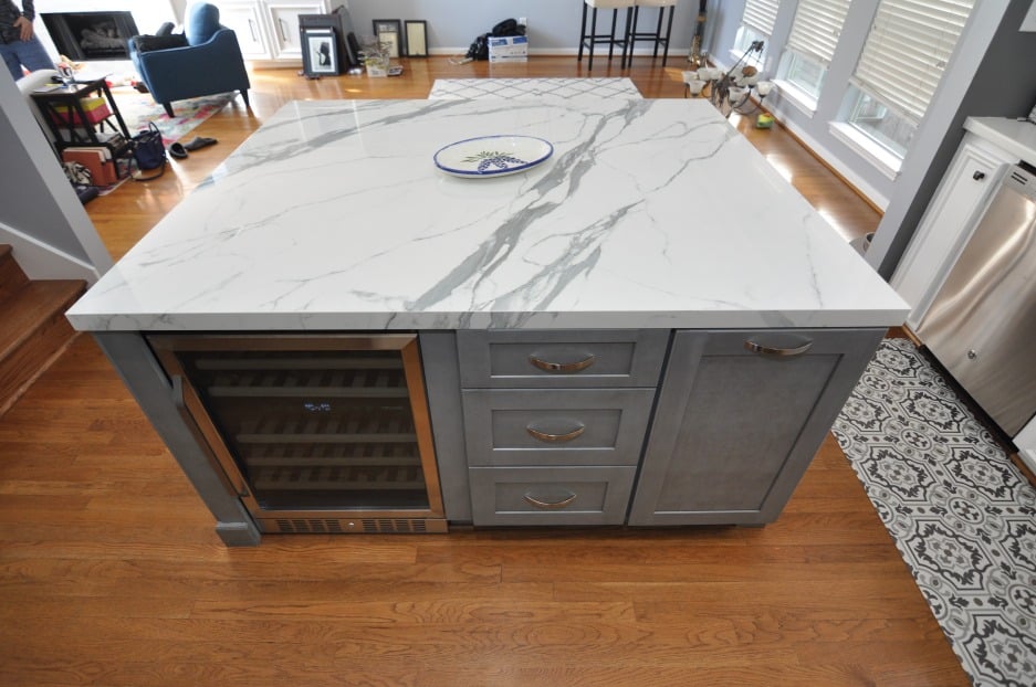 kitchen island with gray cabinets and marble countertop