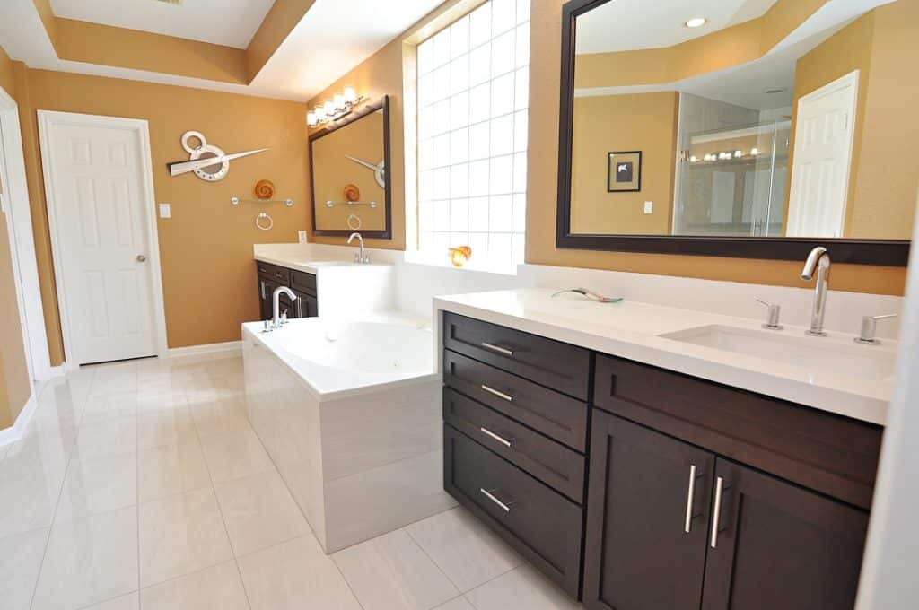 A spacious bathroom featuring a sizable tub and a sink