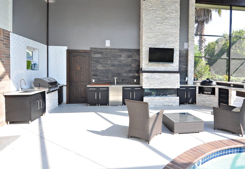 Outdoor kitchen with black cabinets and a grill