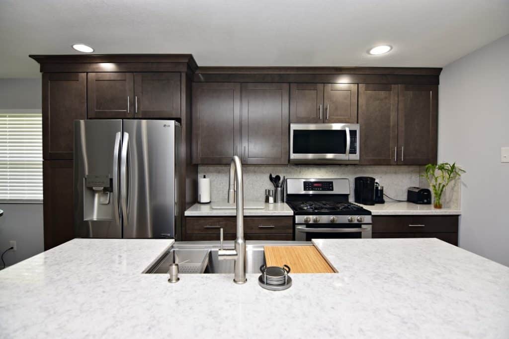 A modern kitchen with sleek stainless steel appliances and elegant granite counter tops