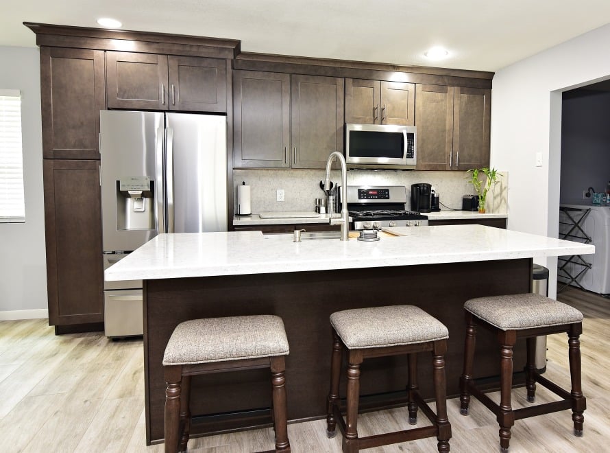 A modern kitchen with a central island and sleek stainless steel appliances