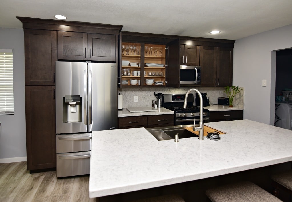 A stylish kitchen with stainless steel appliances and a clean white countertop