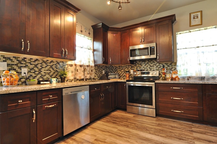 A kitchen with brown cabinets and stainless steel appliances