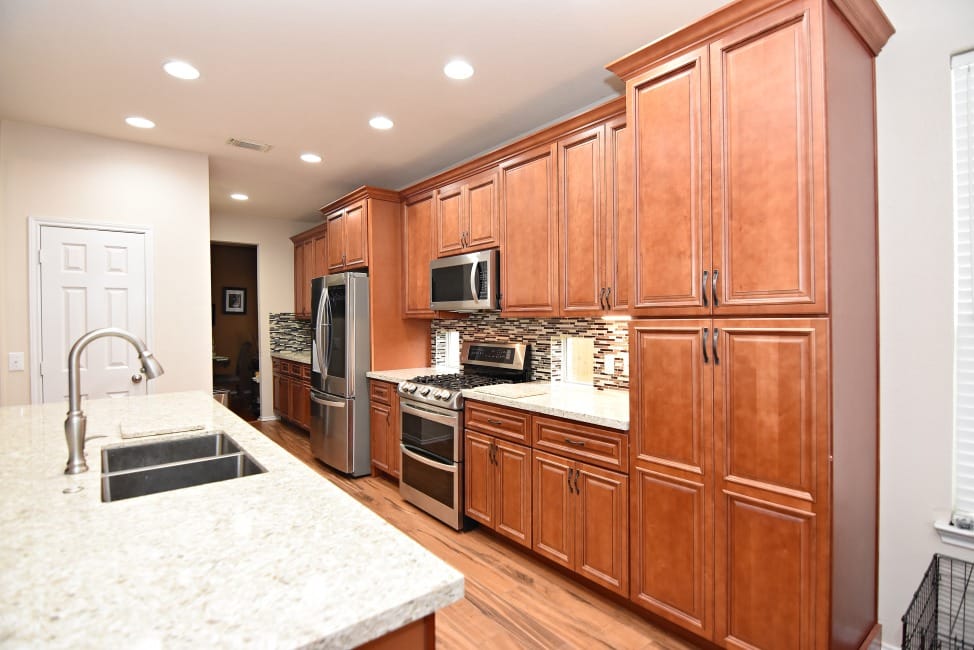 A kitchen with sleek wood cabinets and modern stainless steel appliances