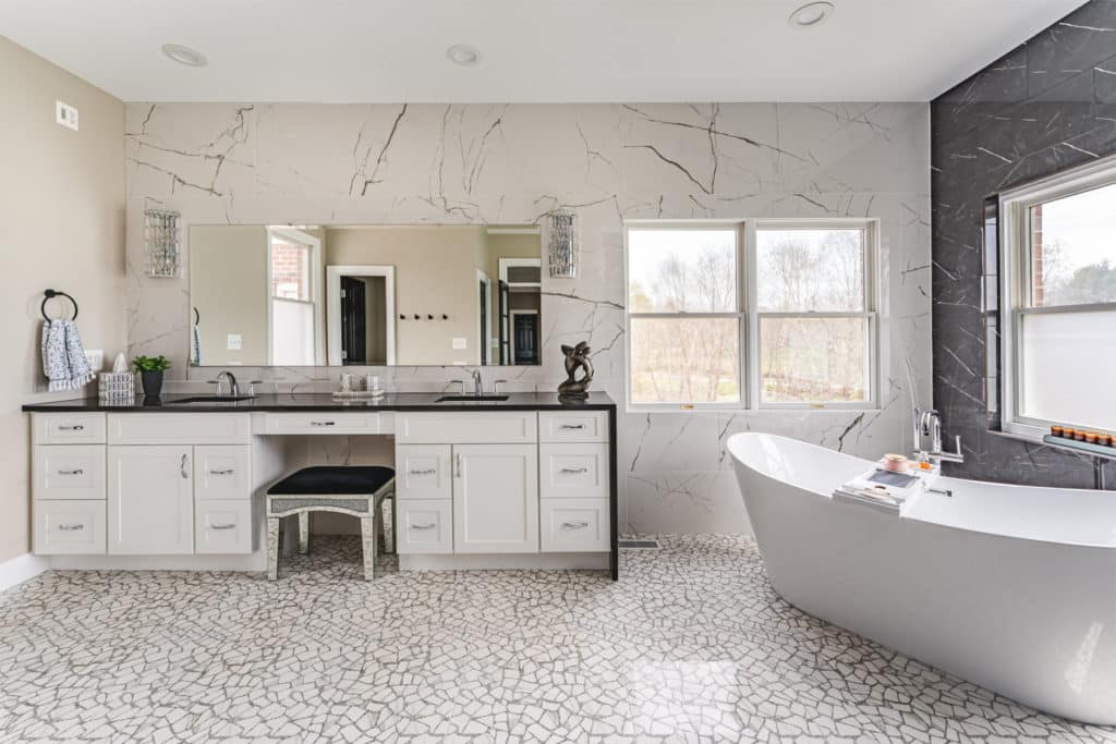 a bathroom with a large tub and a sink