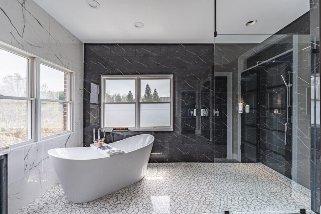 a bathroom with a large tub and a marble walls