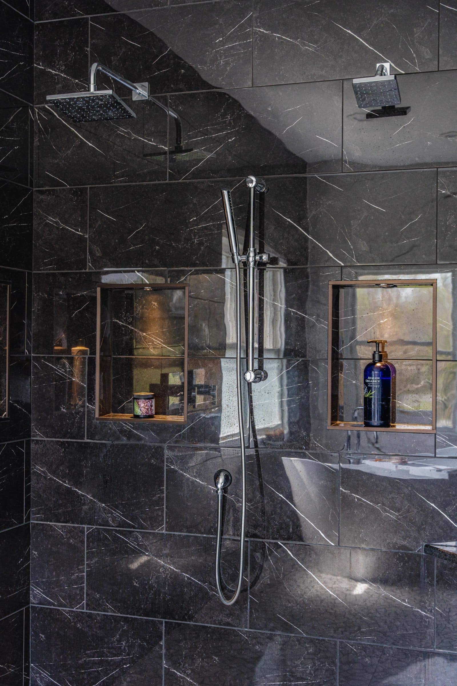 Bathroom with a silver shower and a black walls