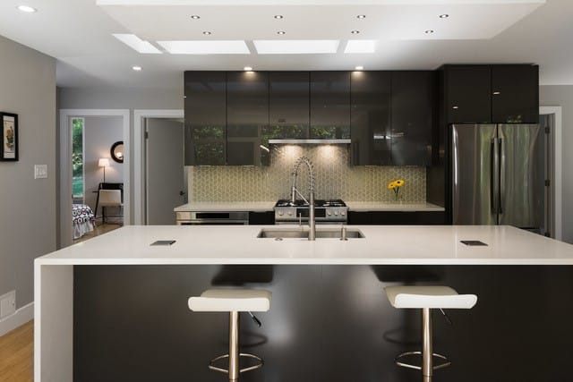 A contemporary kitchen featuring sleek black cabinets