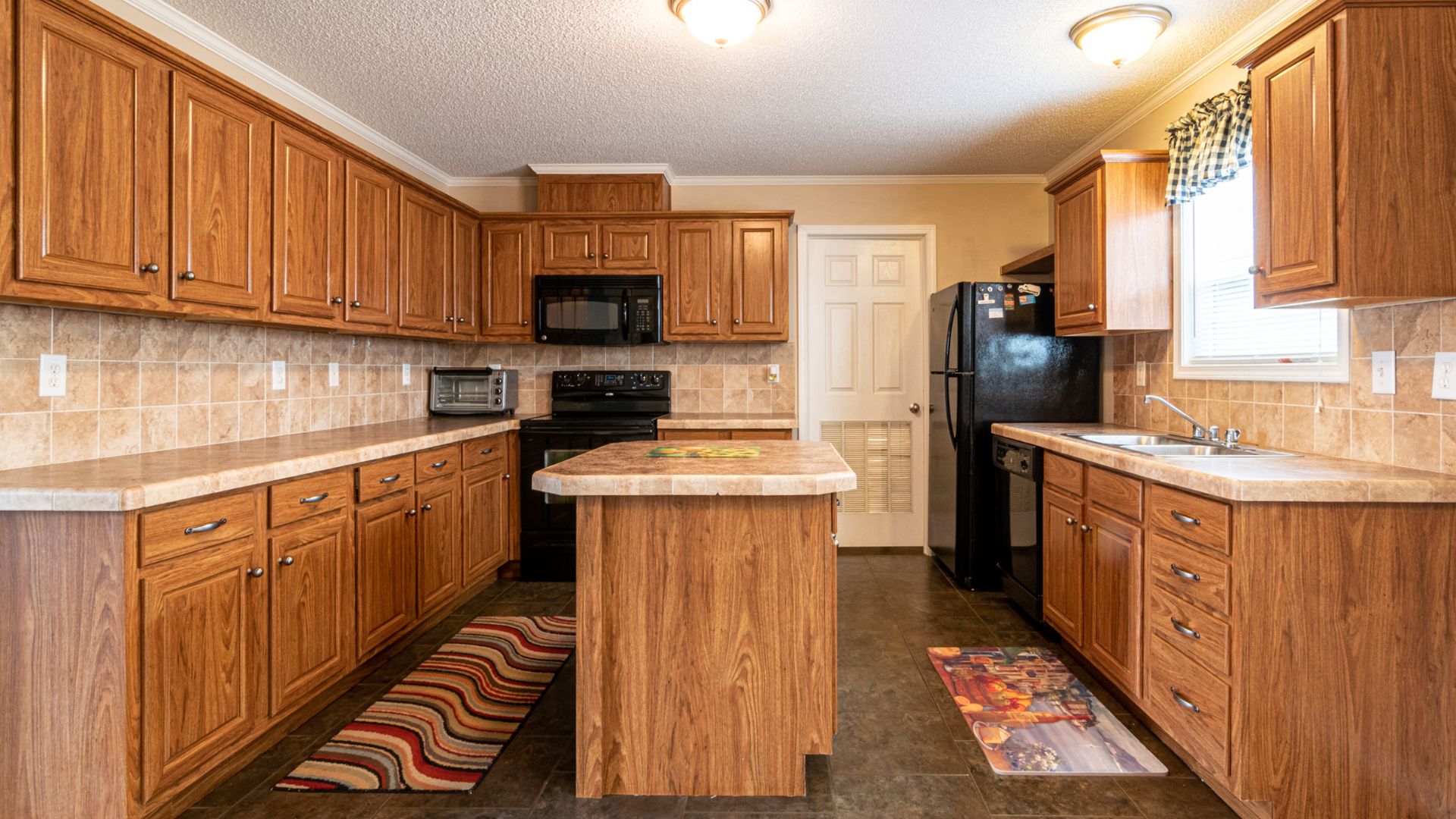 kitchen with wooden cabinets and black appliances