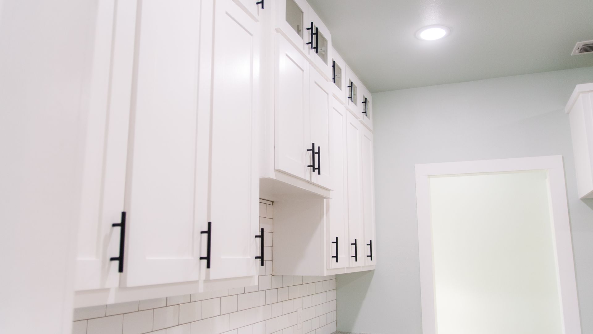 kitchen cabinets with black handles