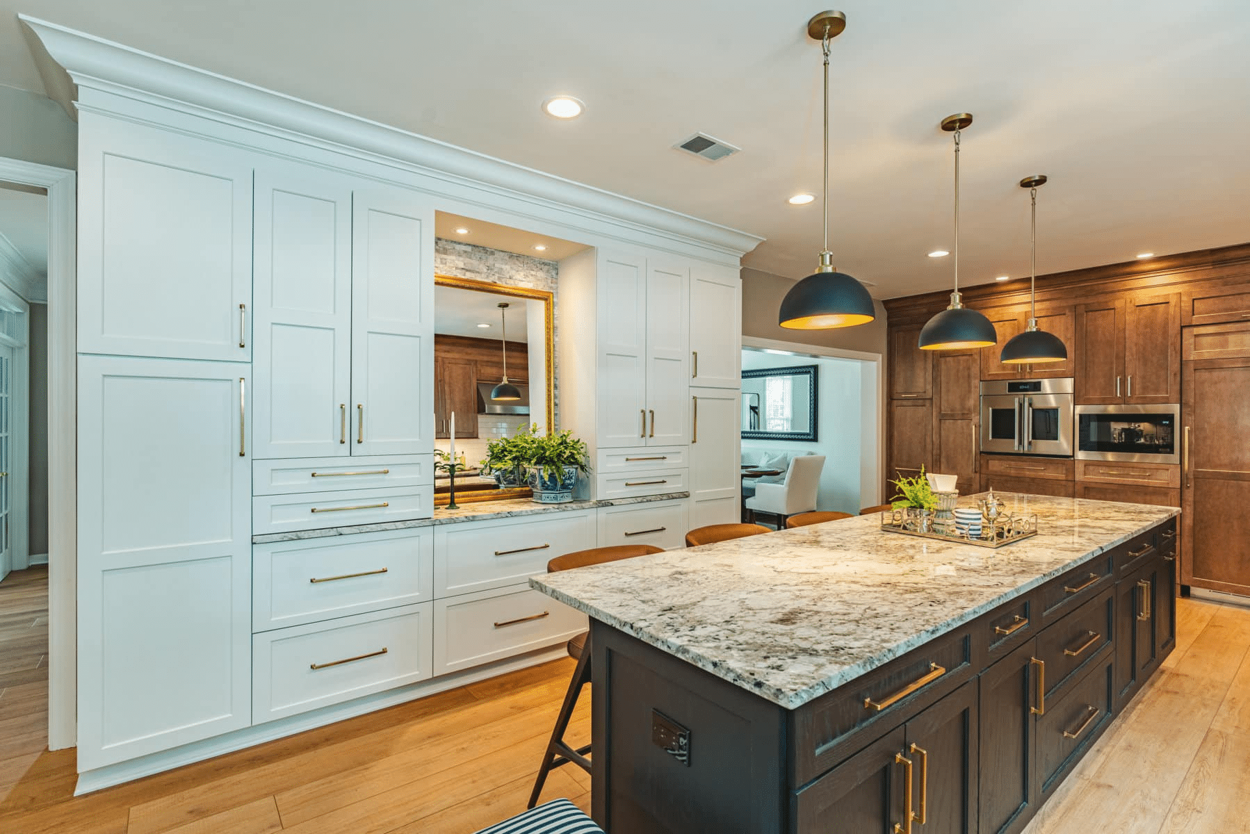 Two-tone kitchen cabinets with marble countertops