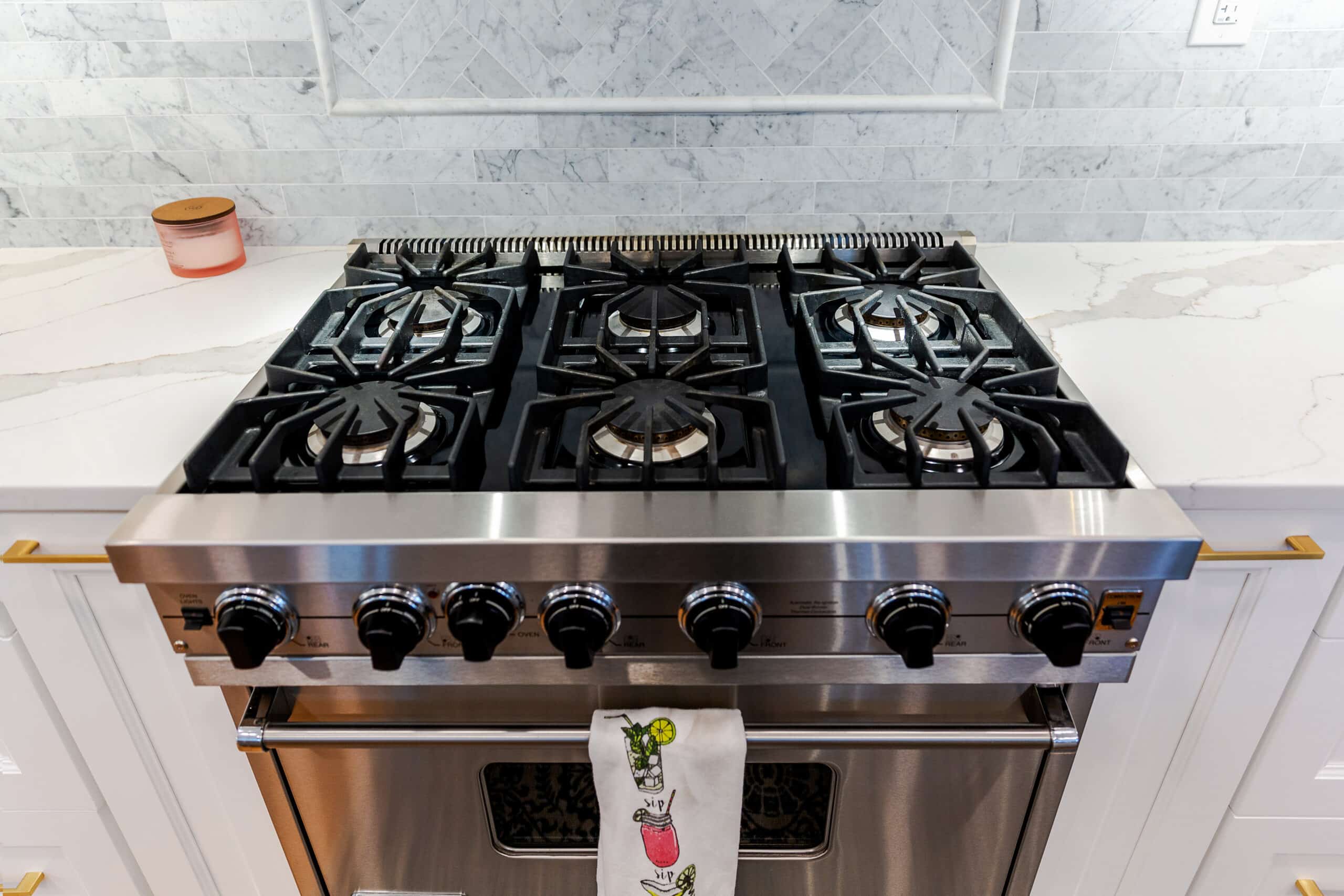 A stainless steel stove and a white marble countertops