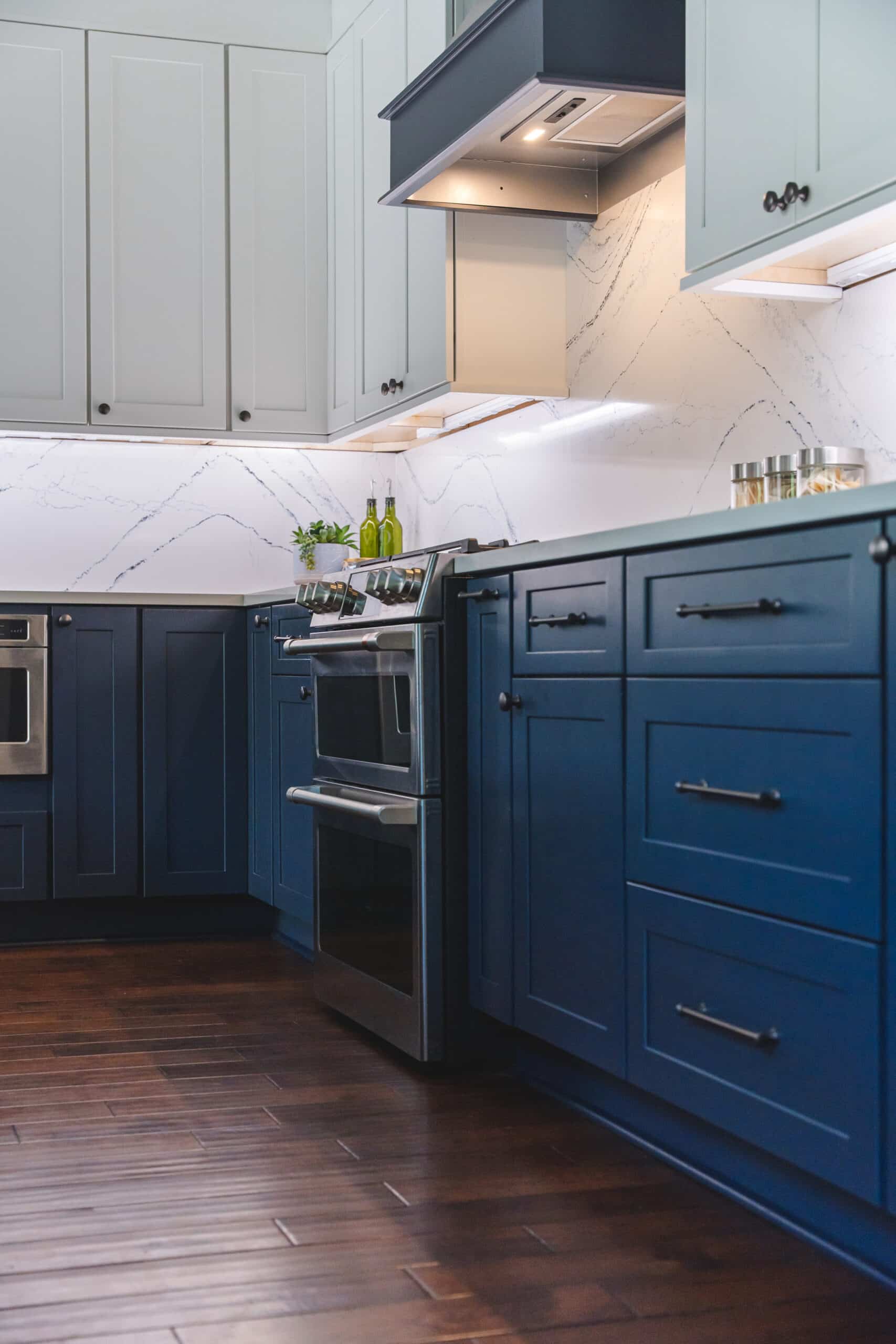 White and blue kitchen cabinets with stove and exhaust