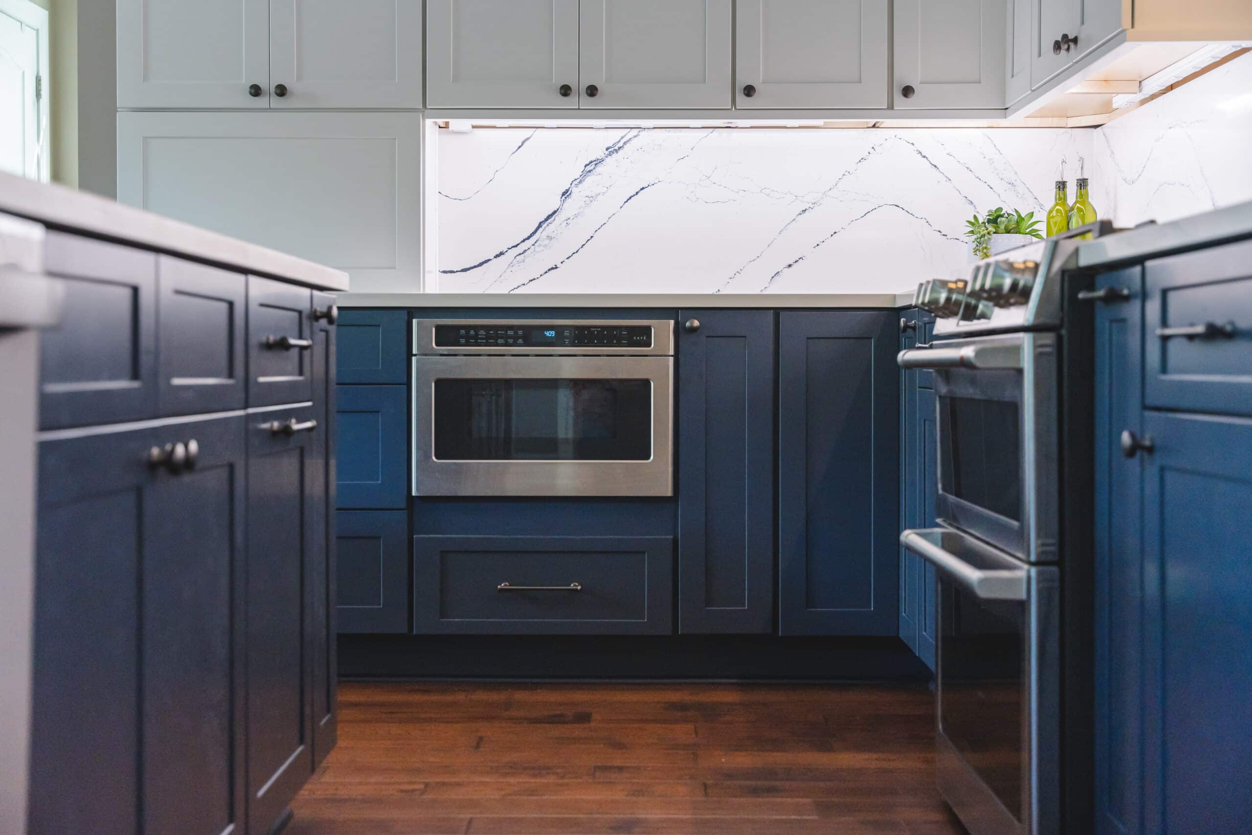 a kitchen with a marble backs and blue cabinets