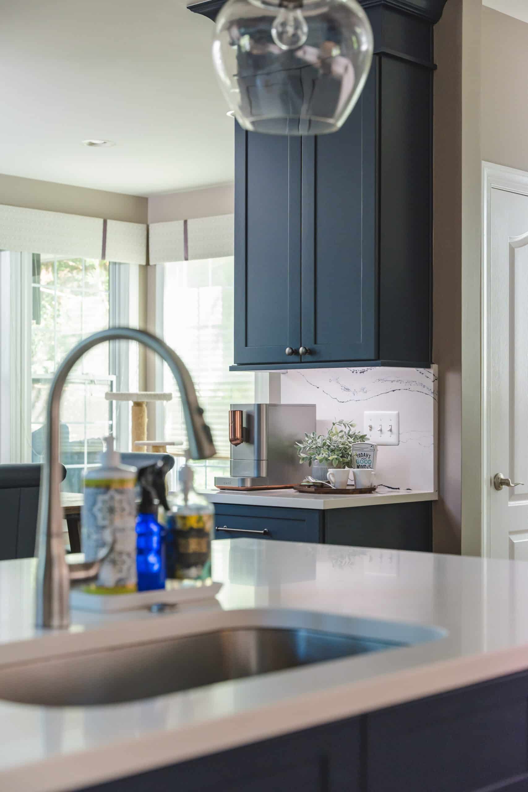 A kitchen with a sink and a blue cabinets