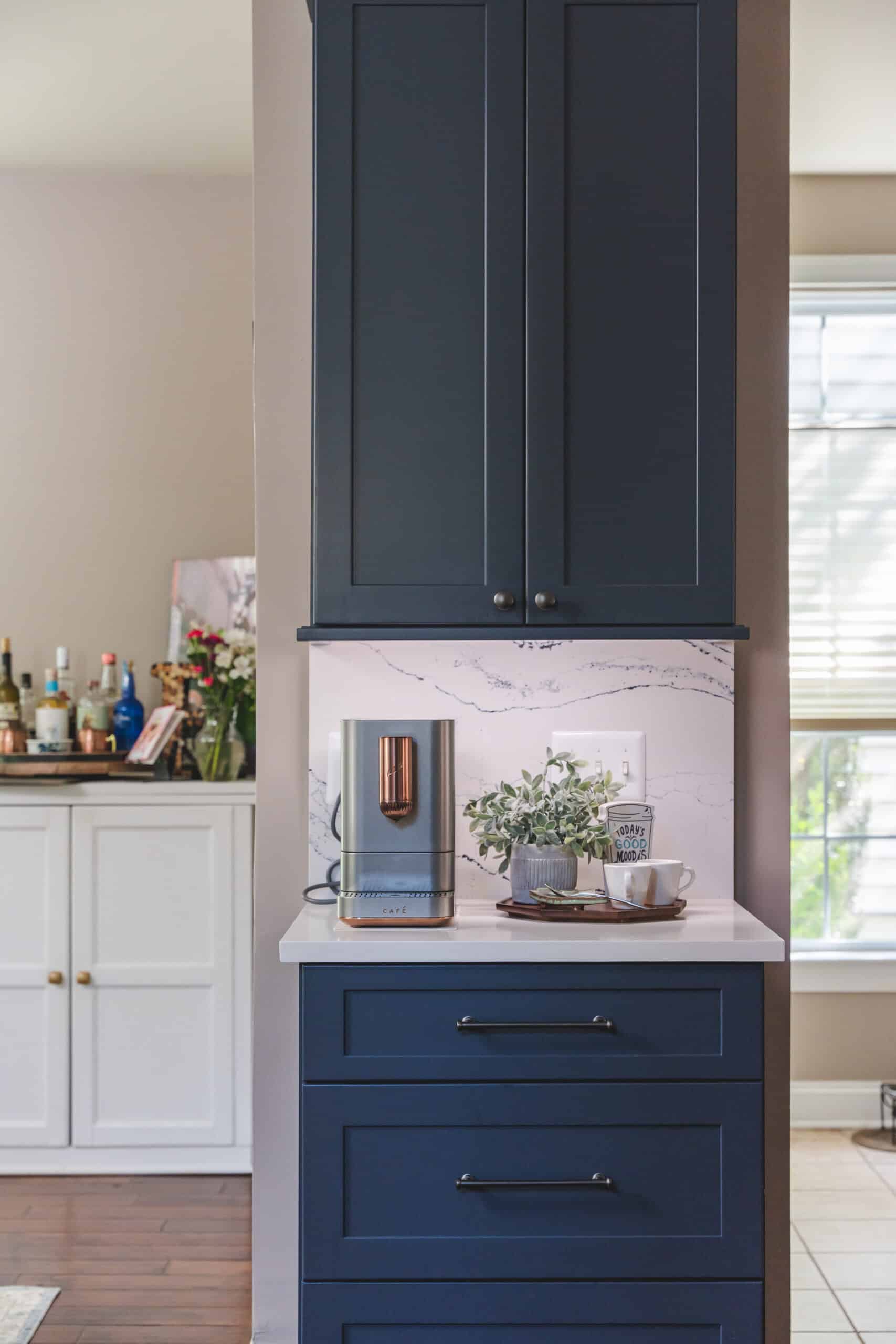 A kitchen with dark blue cabinets and a white countertop
