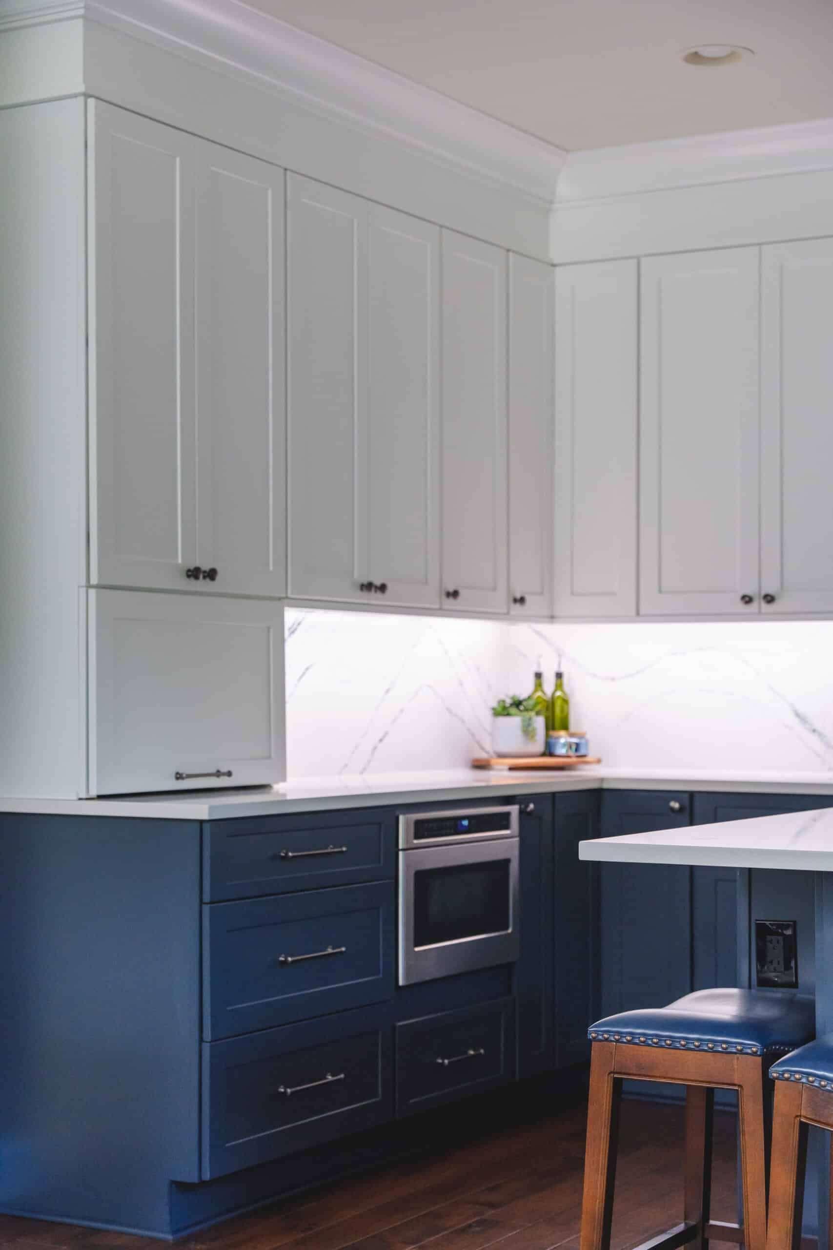 Kitchen with blue cabinets and white countertops