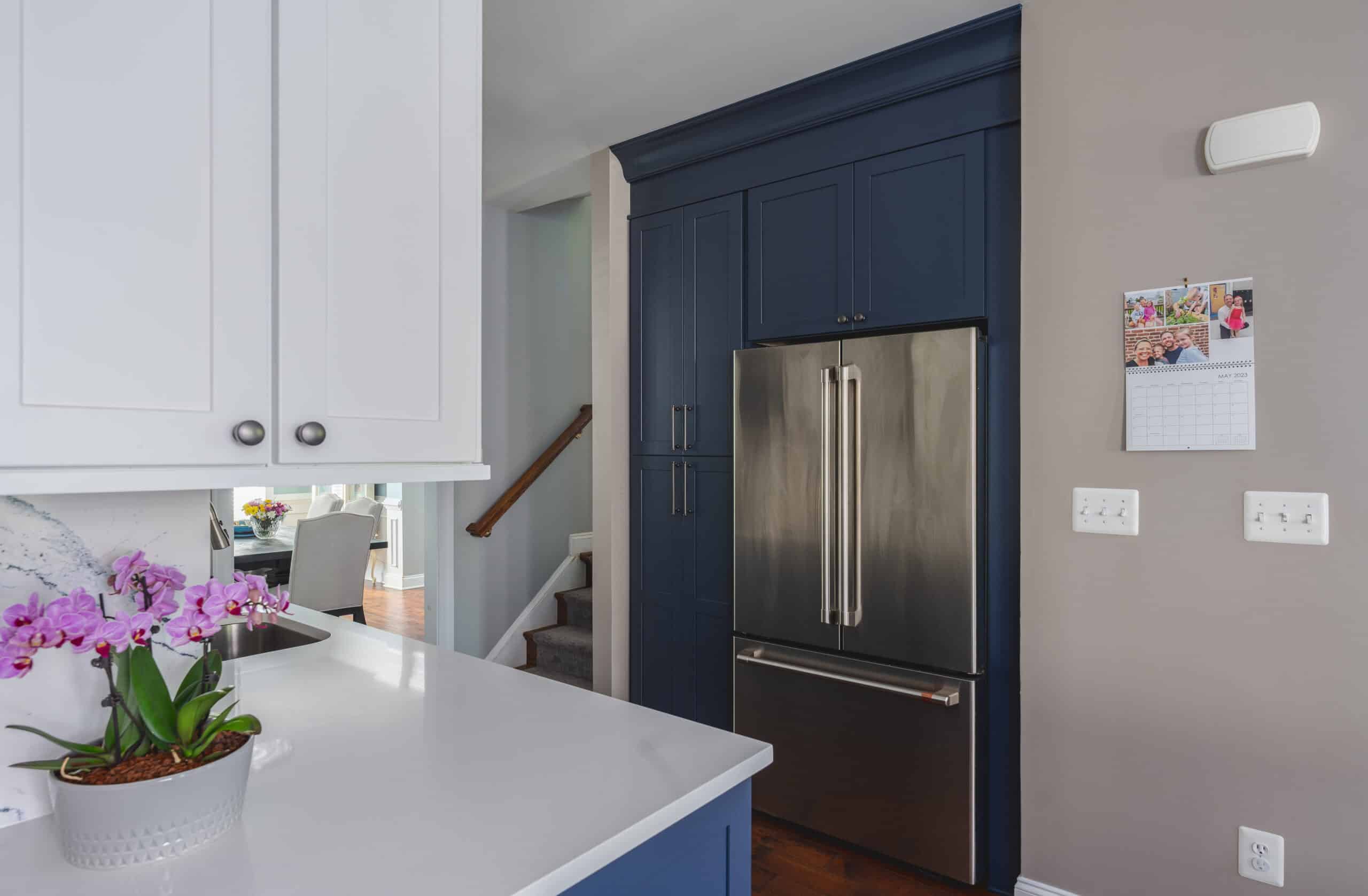 Contemporary kitchen featuring blue cabinets and stainless steel appliances