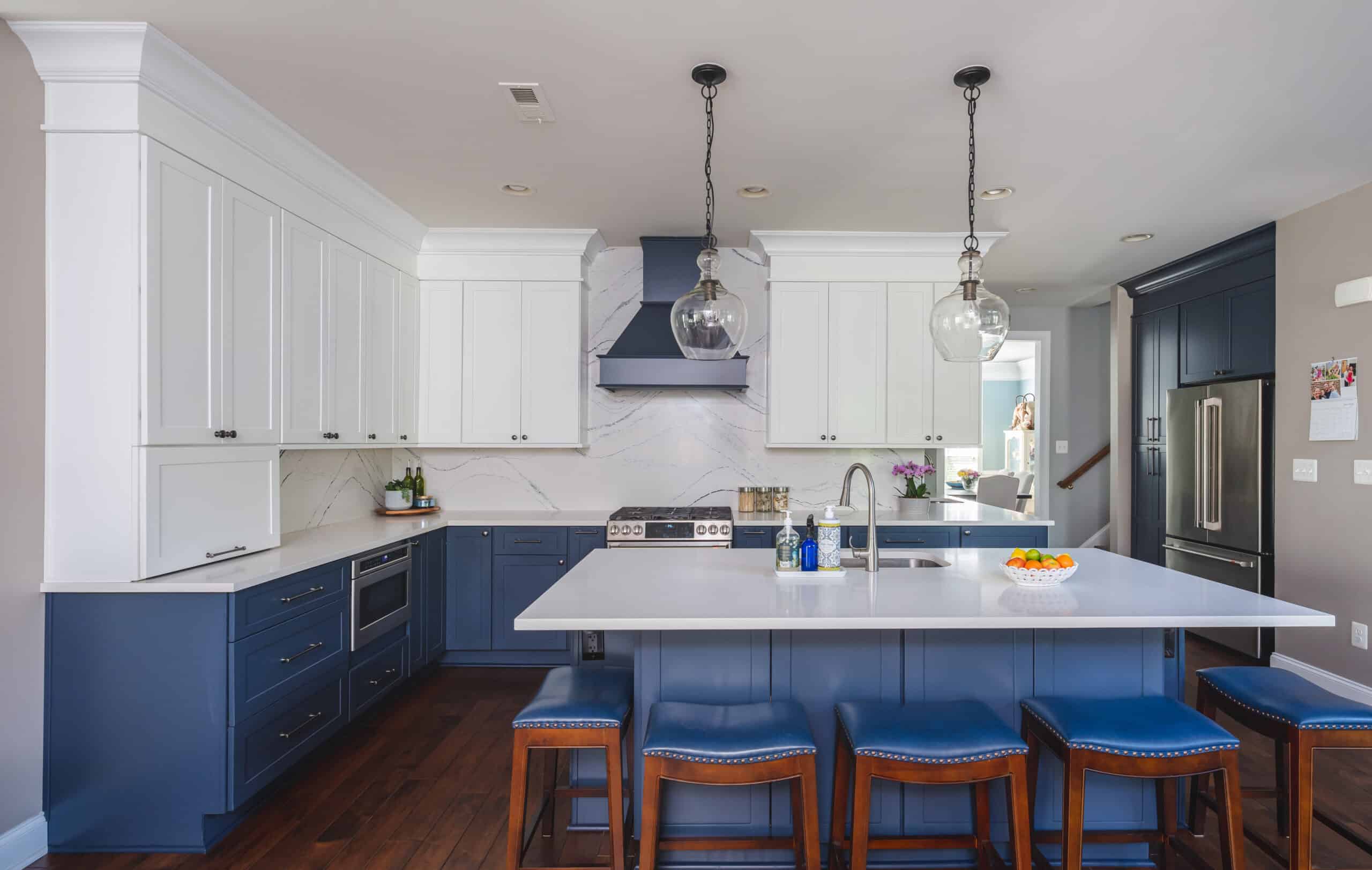 A well-designed kitchen showcasing blue cabinets and stainless steel appliances