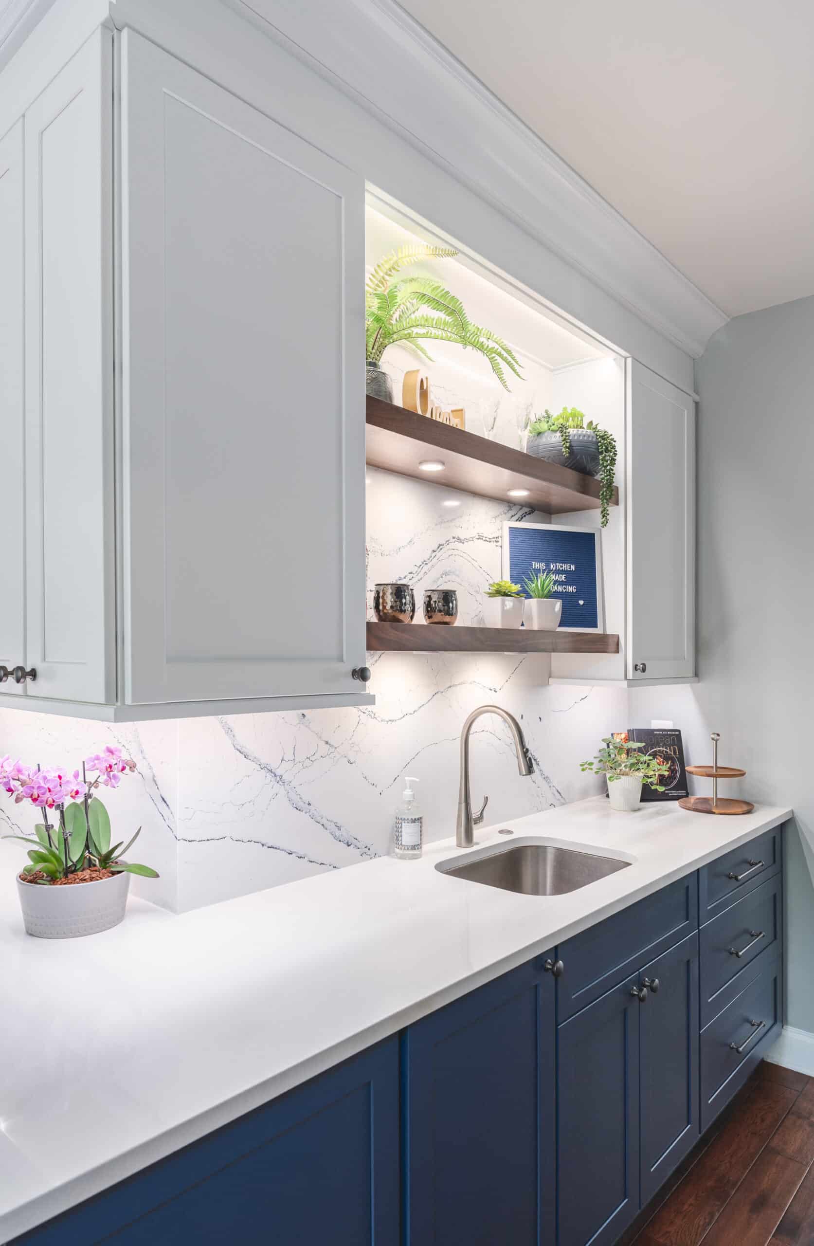 a kitchen adorned with blue cabinets and white counter tops
