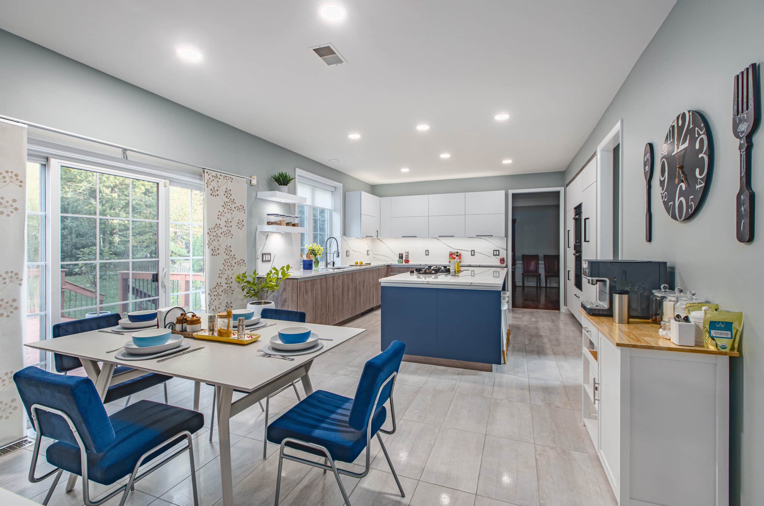 A kitchen with blue chairs and a dining table