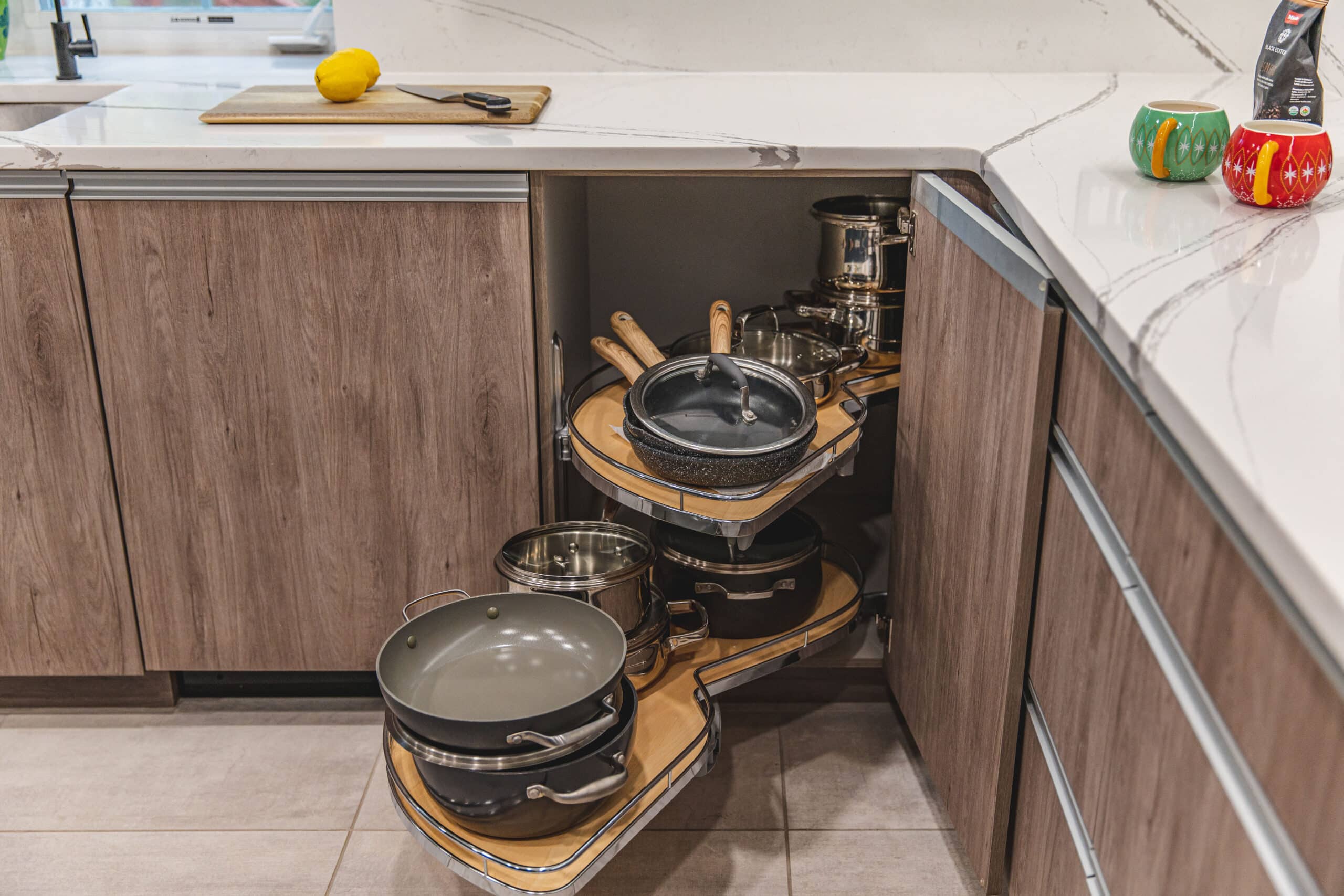 A cluttered kitchen counter with various pots and pans neatly arranged,