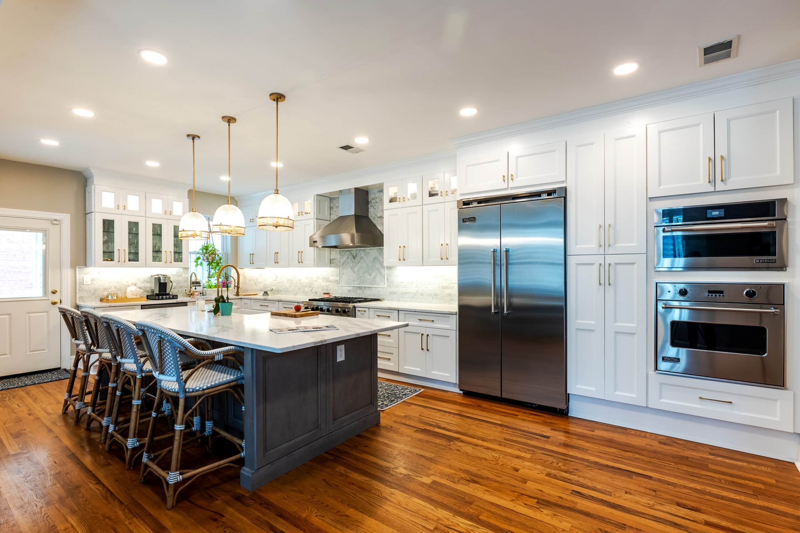 A kitchen with sleek white cabinets and modern stainless steel appliances