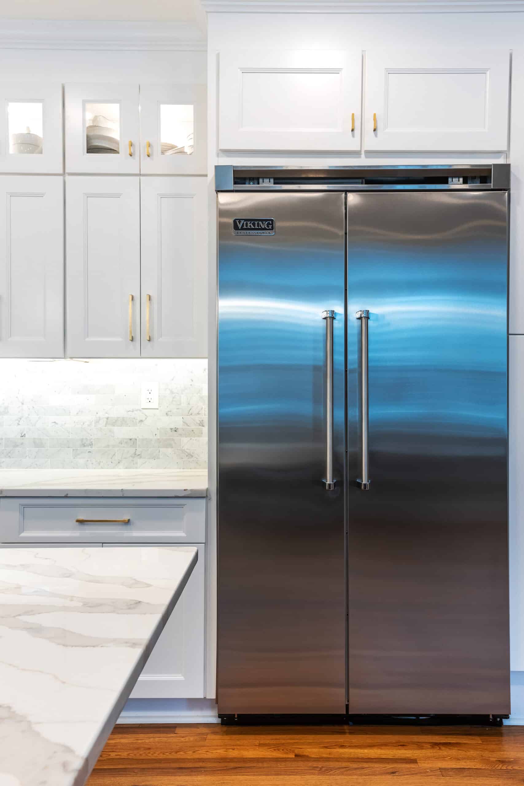 A stainless steel refrigerator in a white kitchen