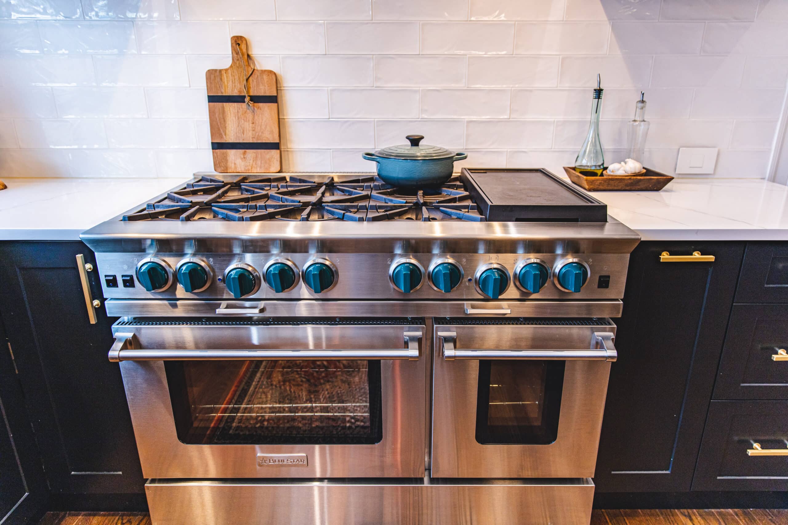 A modern stainless steel stove top oven in a well-lit kitchen