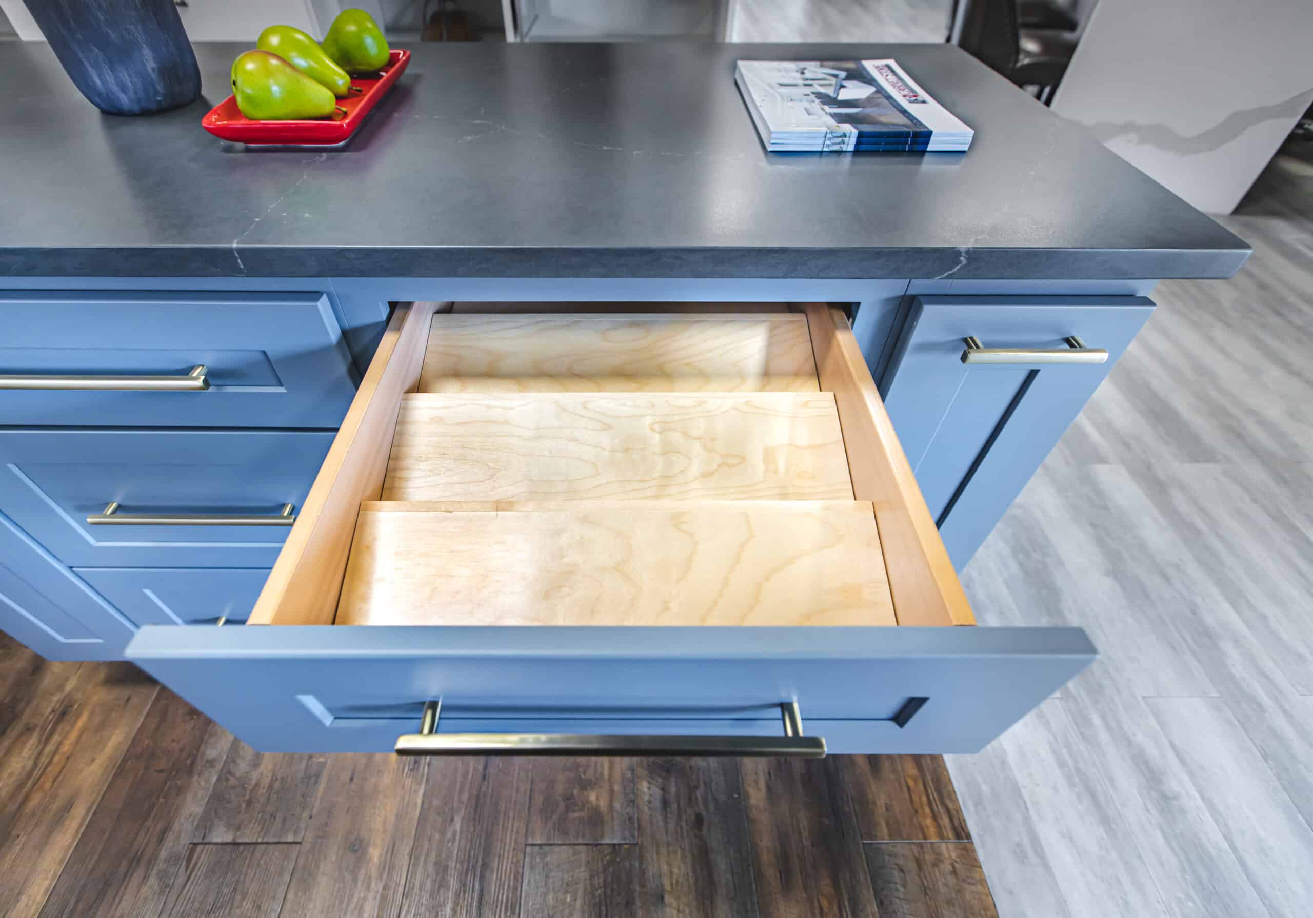 A kitchen island with drawers and a fruit