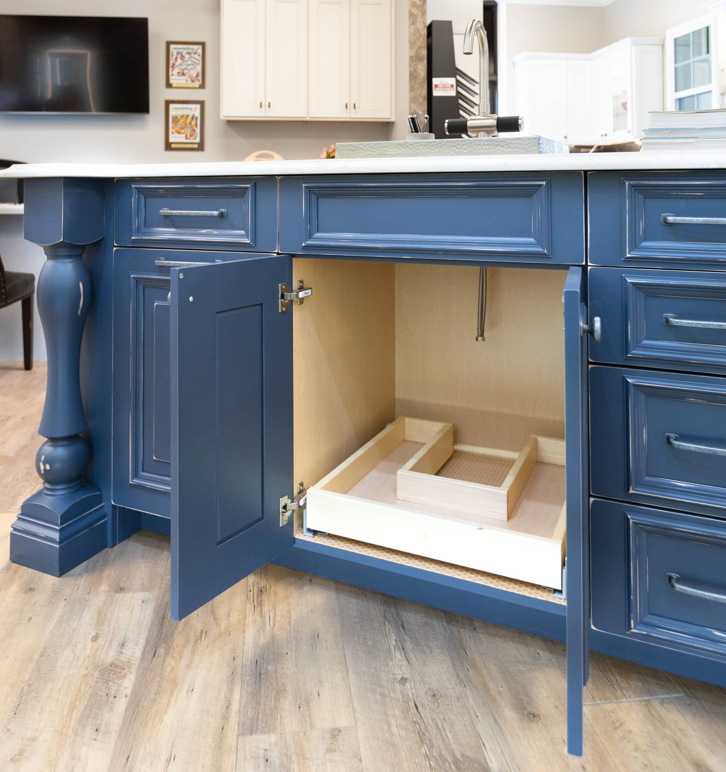 A kitchen island with drawers and a sink