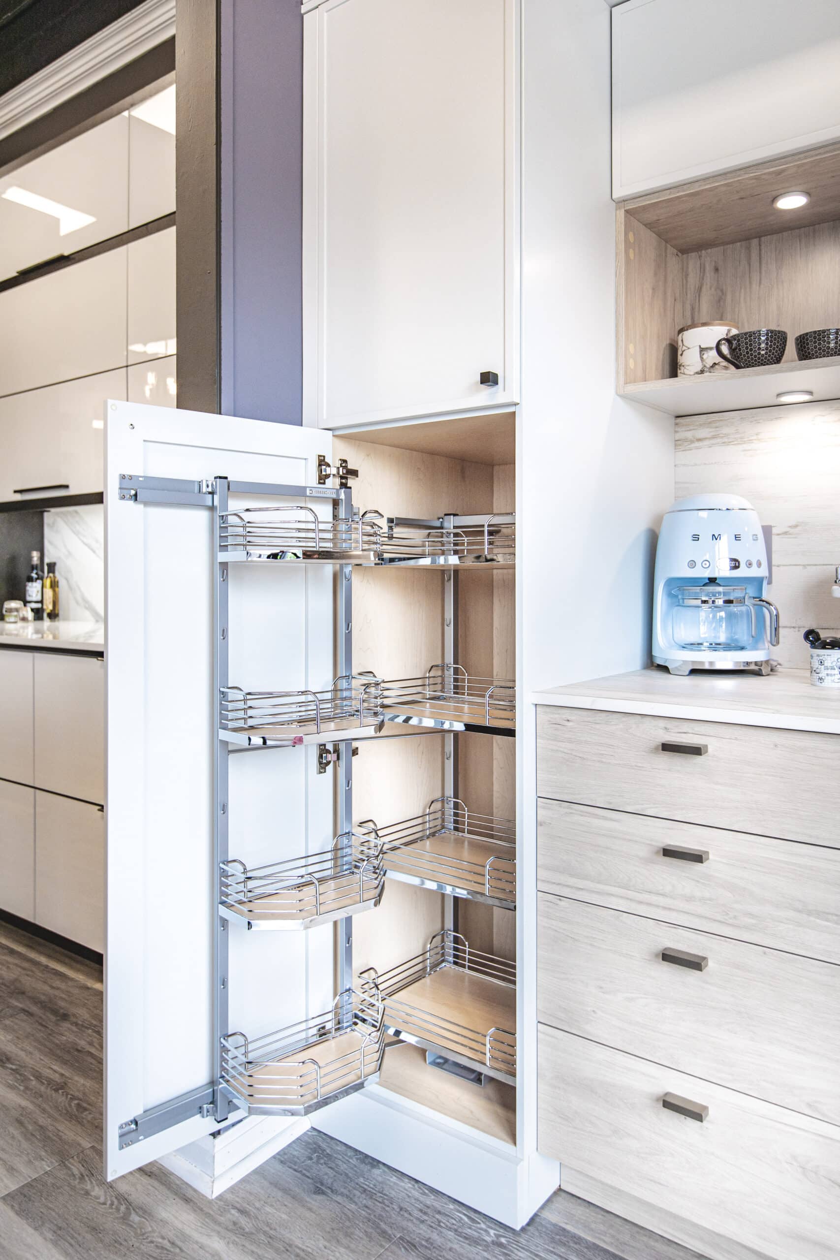 a kitchen with a pull out cabinet