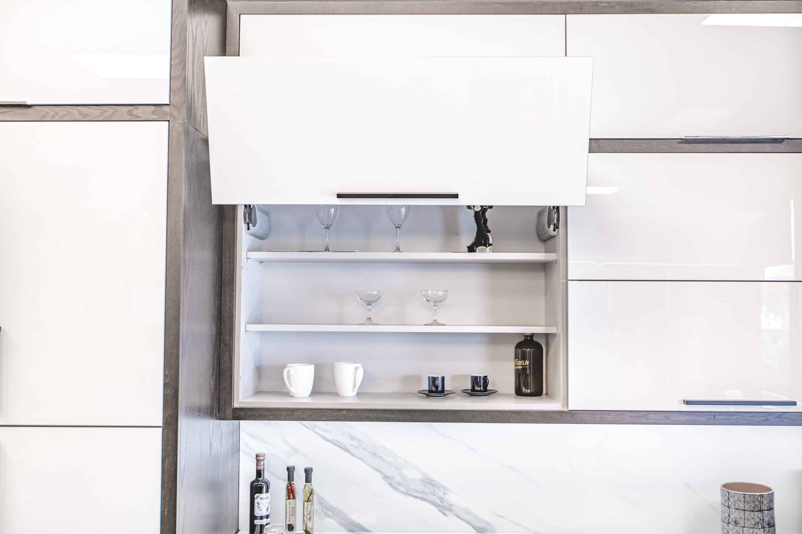 A kitchen with sleek white cabinets and a matching white countertop
