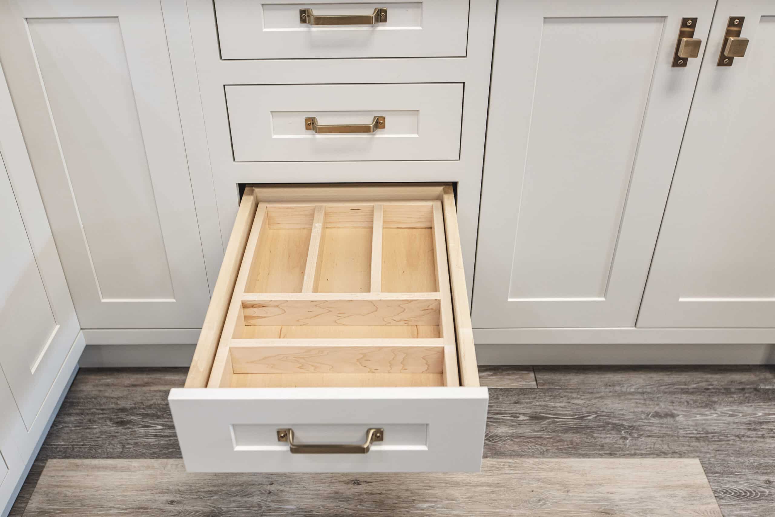 A wooden drawer with two compartments