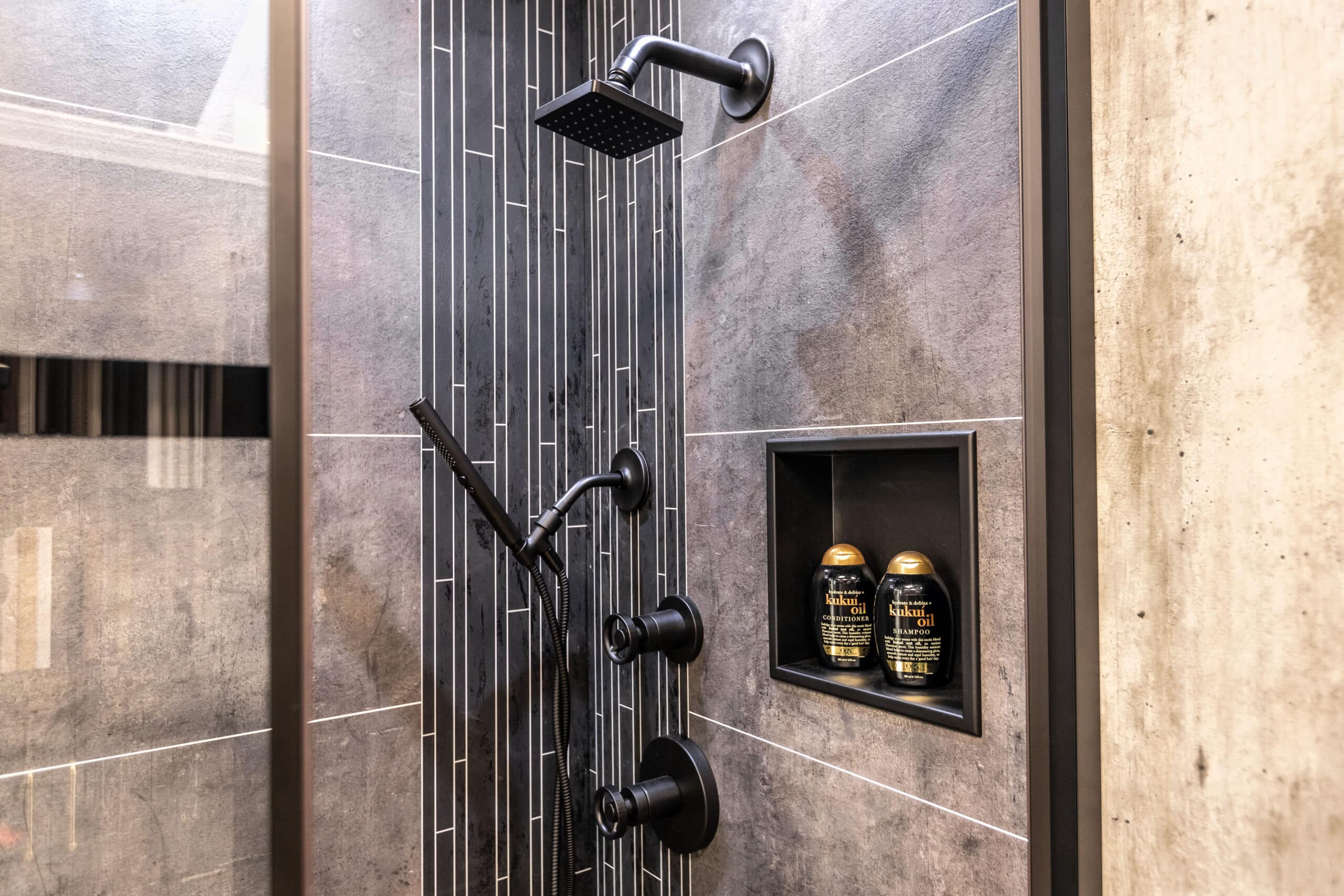 A modern shower with a sleek glass door