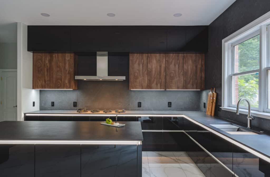 A contemporary kitchen featuring sleek black and black countertops