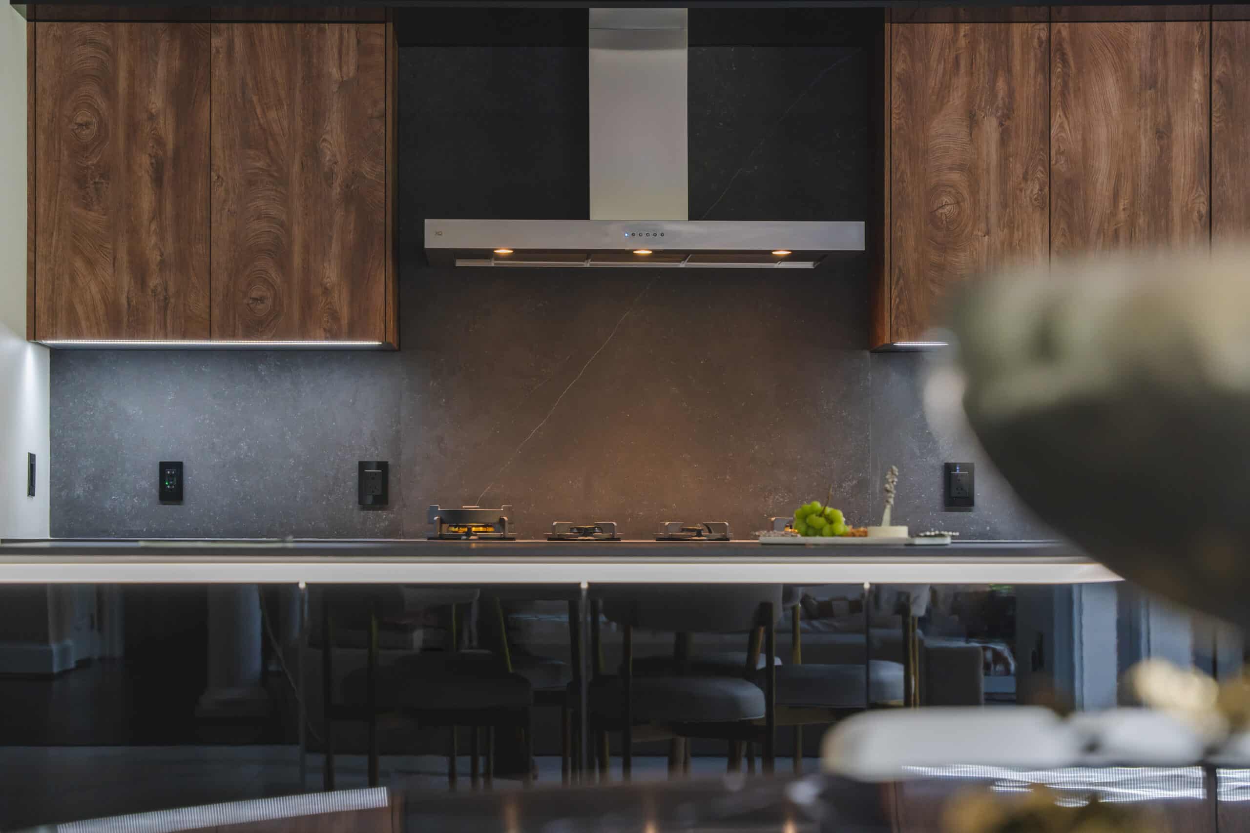 A contemporary kitchen featuring sleek black cabinets and a matching black countertops